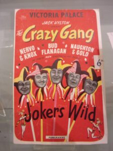 Red poster with text in black, white and yellow. Black and white images of faces in the middle. 