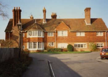 Colour photograph of a light brown house